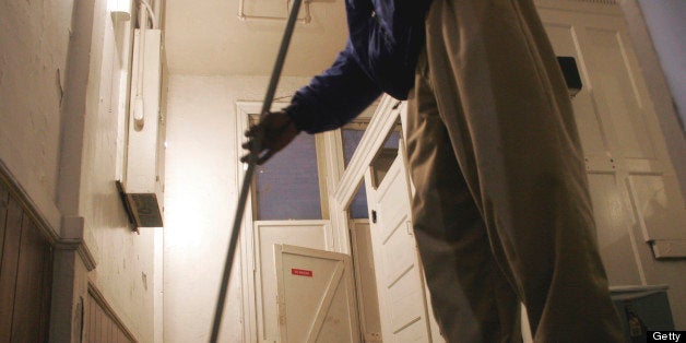 A janitor cleaning the bathroom floor, Nashville, Tennessee.