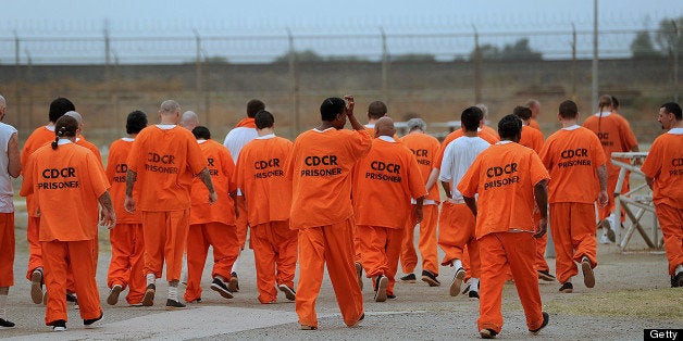 Prisoners walk a lap in a recreation yard at Deuel Vocational Institution in Tracy, California, U.S., on Thursday, Oct. 11, 2012. The primary purpose of the Deuel Vocational Institution is to serve as a reception center for newly-committed prisoners to the California Department of Corrections and Rehabilitation from northern California county jails as well as house a small number of minimum and low security inmates. Photographer: Noah Berger/Bloomberg via Getty Images