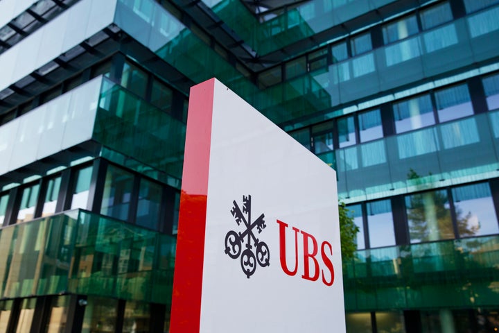 The UBS AG logo stands outside the bank's offices in Basel, Switzerland, on Tuesday, July 23, 2013. Europe's biggest banks, w