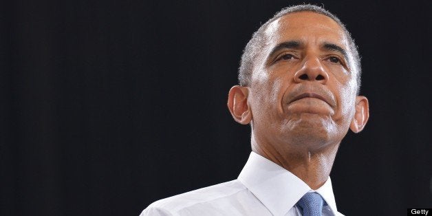 US President Barack Obama pauses as he speaks on home ownership for the middle class at Desert Vista High School on August 6,