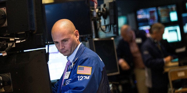 NEW YORK, NY - AUGUST 06: A trader works on the floor of the New York Stock Exchange at the end of the trading day on August 6, 2013 in New York City. The Dow Jones Industrial average had slipped nearly 100 points by the closing bell. (Photo by Andrew Burton/Getty Images)