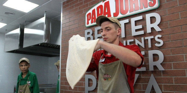 An employee shapes dough for a pizza base at a Papa John's International Inc. pizza restaurant in Moscow, Russia, on Tuesday,