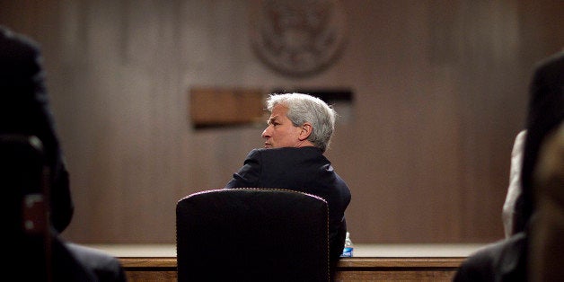 Bloomberg's Best Photos 2012: The Newsmakers. Time after time in 2012, Bloomberg photographers came through with striking, pointed, poignant and just plain beautiful images -- From Jamie Dimon in the U.S. and Bob Diamond in the U.K. testifying to governmental committees, to Sheldon Adelson surrounded by lion dancers in Macau, China, to Warren Buffett and Bill Gates at the annual Berkshire Hathaway shareholders meeting, see their work here in Newsmakers. FILE PHOTO: 'BEST PHOTOS OF 2012' (***BESTOF2012***): Jamie Dimon, chief executive officer of JPMorgan Chase & Co., talks to an assistant during a Senate Banking Committee hearing in Washington, D.C., U.S., on Wednesday, June 13, 2012. Dimon said the bank will probably seek to claw back pay from executives responsible for $2 billion in trading losses. Photographer: Andrew Harrer/Bloomberg via Getty Images