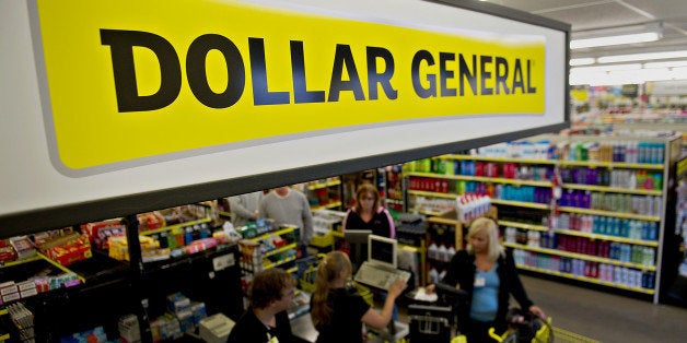 A sign hangs over cash registers at a Dollar General Corp. store in Creve Coeur, Illinois, U.S., on Thursday, May 31, 2012. U.S. consumer spending rose in April, a sign that households are supporting the economy as the labor market seeks to gain momentum. Dollar General Corp. is scheduled to announce quarterly earnings on June 4. Photographer: Daniel Acker/Bloomberg via Getty Images