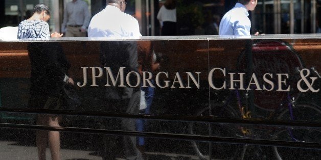 People walk by JP Morgan Chase & Company headquarters in New York, August 14, 2013. The US August 14, 2013 charged a pair of former JPMorgan Chase traders with fraud in connection with the 2012 $6.2 billion 'London whale' trading losses. Federal prosecutors filed criminal charges against Javier Martin-Artajo and Julien Grout, alleging the two men kept false records on the trades, committed wire fraud and submitted false US securities filings. AFP PHOTO/Emmanuel Dunand (Photo credit should read EMMANUEL DUNAND/AFP/Getty Images)