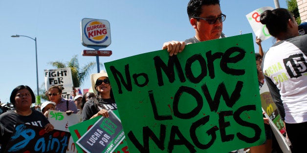 Fast-food workers and supporters organized by the Service Employees International Union (SEIU) protest outside of a Burger King Worldwide Inc. restaurant in Los Angeles, California, U.S., on Thursday, Aug. 29, 2013. Fast-food workers in 50 U.S. cities plan to walk off the job today, ratcheting up pressure on the industry to raise wages and demanding the right to wages of $15 an hour, more than double the federal minimum of $7.25. Photographer: Patrick T. Fallon/Bloomberg via Getty Images