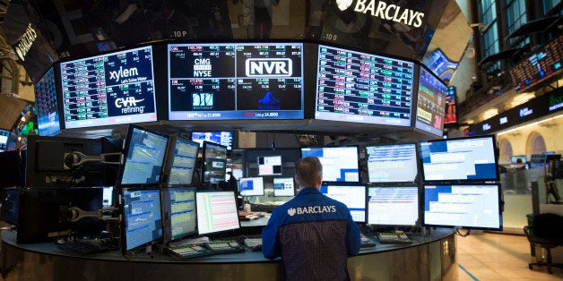 A trader works on the floor of the New York Stock Exchange (NYSE) in New York, U.S., on Wednesday, Aug. 21, 2013. U.S. stocks fell, giving the Dow Jones Industrial Average its longest slump in 13 months, as minutes of the Federal Reserve's July meeting showed officials support stimulus cuts this year if the economy improves. Photographer: Scott Eells/Bloomberg via Getty Images