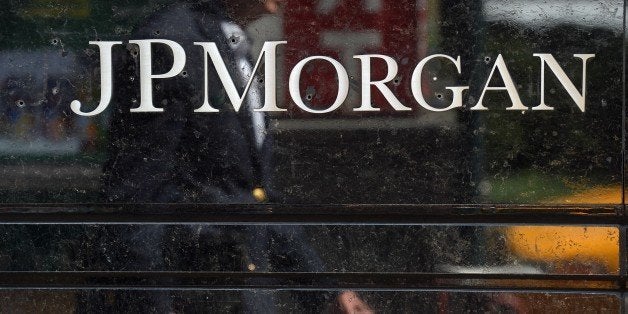 People walk by JP Morgan Chase & Company headquarters in New York, August 14, 2013. The US August 14, 2013 charged a pair of