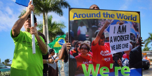 HIALEAH, FL - DECEMBER 14: Protesters participate in a 'Global Day' of action against Walmart on December 14, 2012 in Hialeah, Florida. The protesters in partnership with the global union federation UNI, the union-affiliated group Making Change at Walmart joined others around the world to among other things call for an end to alleged retaliation against US Walmart worker activists. (Photo by Joe Raedle/Getty Images)