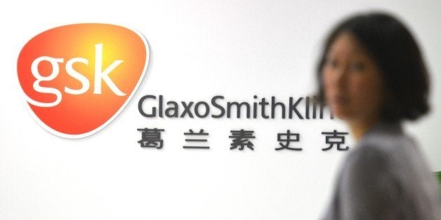 An employee of British drug firm GlaxoSmithKline (GSK) enters their office headquarters in Shanghai on July 1, 2013. Chinese
