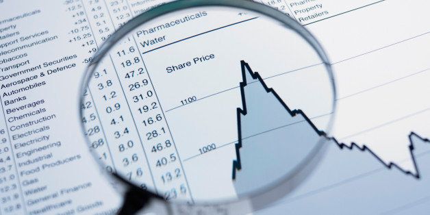 Magnifying glass and descending line graph and list of share prices