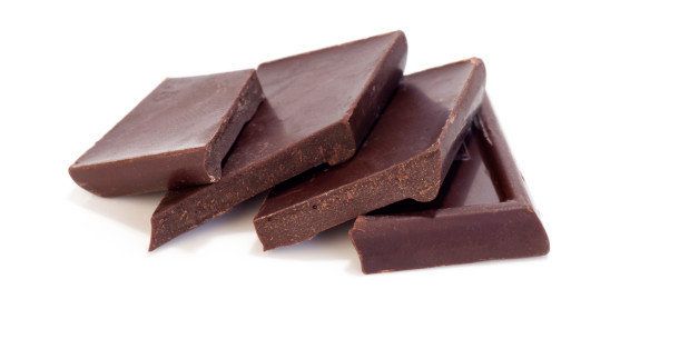 Pieces of dark chocolate on a white background