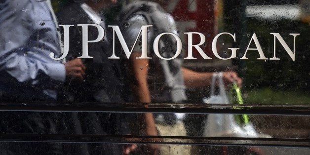 People walk by JP Morgan Chase & Company headquarters in New York, August 14, 2013. The US August 14, 2013 charged a pair of