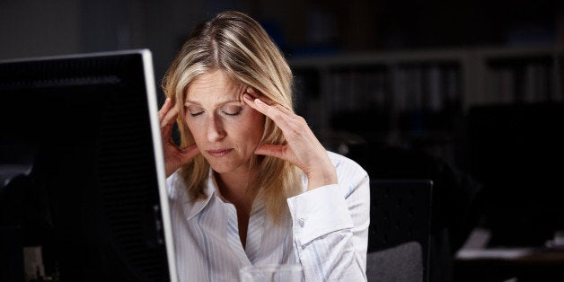 Stressed businesswoman working late