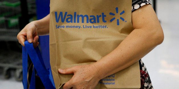 A customer carries a Walmart paper shopping bag during the grand opening of a Wal-Mart Stores Inc. location in the Chinatown neighborhood of Los Angeles, California, U.S., on Thursday, Sept. 19, 2013. Wal-Mart Stores Inc. will phase out 10 chemicals it sells in favor of safer alternatives and disclose the chemicals contained in four product categories, the company announced Sept. 12.Photographer: Patrick T. Fallon/Bloomberg via Getty Images