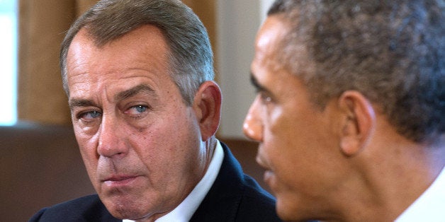 Speaker of the House John Boehner (L), R-OH, listens as US President Barack Obama delivers a statement on Syria during a meeting with members of Congress at the White House in Washington, DC, September 3, 2013. Obama told congressional leaders that Syrian President Bashar al-Assad needs to be held accountable for allegedly carrying out the August 21 attack near Damascus, which US officials say killed nearly 1,500 people, including hundreds of children. AFP PHOTO/Jim WATSON (Photo credit should read JIM WATSON/AFP/Getty Images)