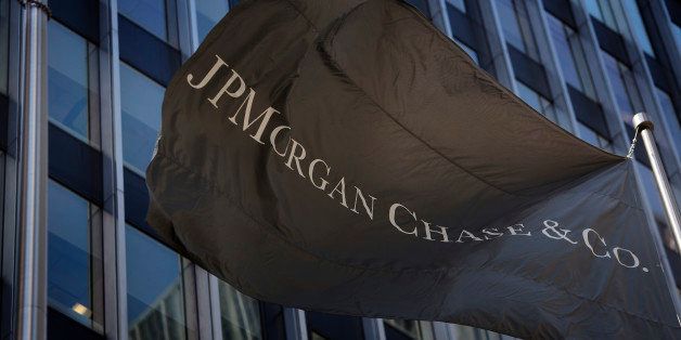 A flag with the JPMorgan Chase & Co. logo flies in front of the company's offices in New York, U.S., on Thursday, April 11, 2013. As JPMorgan Chase & Co.?s Jamie Dimon prepares for a vote tomorrow on whether he should keep his chairman and chief executive officer titles, he may take comfort knowing most of his biggest shareholders are led by men with the same dual role. Photographer: Victor J. Blue/Bloomberg via Getty Images