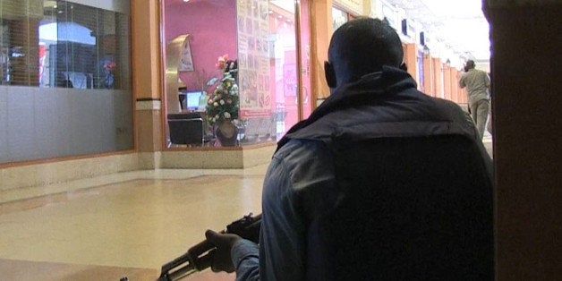 An image grab taken from AFP TV shows a member of the Kenyan security forces taking position inside a shopping mall following