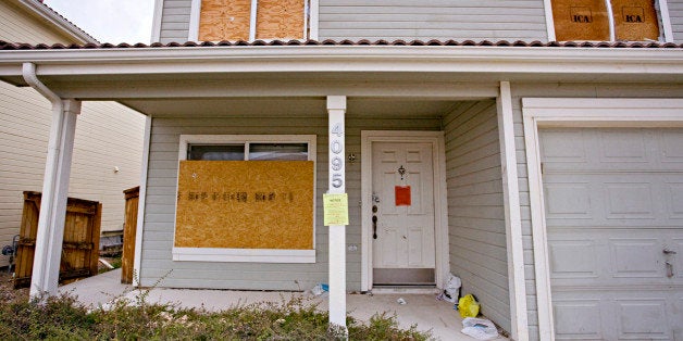 Wooden boards cover the windows of an abandoned home in Denver, Colorado, U.S., on Tuesday, Oct. 27, 2009. Previously owned h