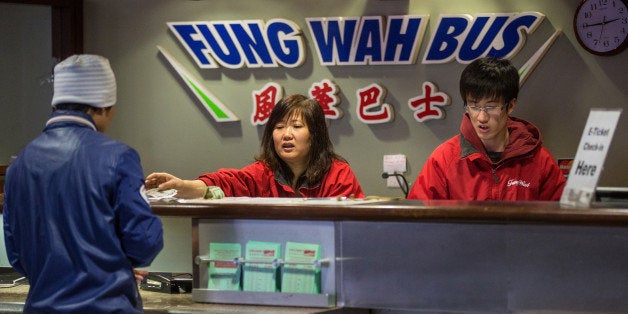 BOSTON - FEBRUARY 26: A worker at the Fung Wah Bus ticket booth sold passengers tickets for a 3 p.m. Fung Wah bus headed to N