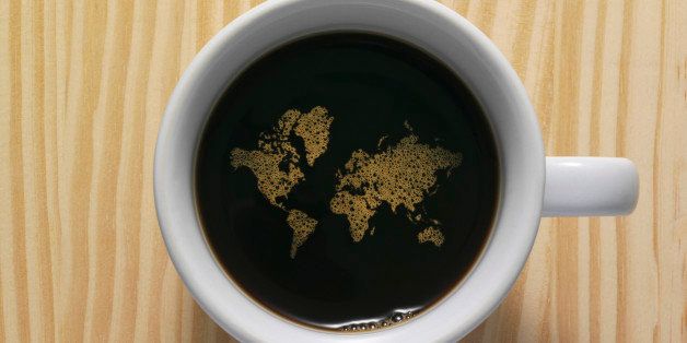 Coffee cup with world map composed of bubbles