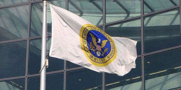 UNITED STATES - OCTOBER 26: A flag waves in front of the headquarters of the Securities and Exchange Commission in Washington, D.C., October 26, 2006. The SEC, criticized by Congress for its handling of a trading probe that entangled Morgan Stanley Chief Executive Officer John Mack, faces a broad review by government auditors of its management and methods for policing the financial markets. (Photo by Dennis Brack/Bloomberg via Getty Images)