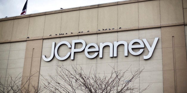 Birds roost as a U.S. flag flies outside of a J.C. Penney Co. store in the Queens borough of New York, U.S., on Tuesday, Feb.