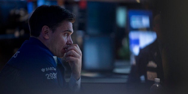 A trader works on the floor of the New York Stock Exchange (NYSE) in New York, U.S., on Wednesday, Oct. 9, 2013. U.S. stocks rose, after the benchmark index's biggest two-day slump since June, amid optimism that Janet Yellen will not rush to withdraw stimulus and signs that lawmakers could raise the debt ceiling. Photographer: Scott Eells/Bloomberg via Getty Images