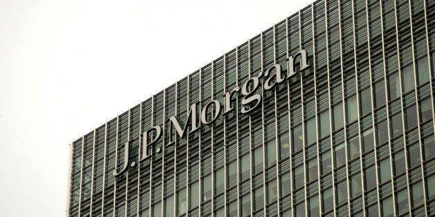 A logo sits on display outside the offices of JPMorgan Chase & Co. in the Canary Wharf business and shopping district in London, U.K., on Tuesday, Sept. 17, 2013. Two former JPMorgan Chase & Co. traders were indicted for engaging in a securities fraud to hide trading losses that eventually surpassed $6.2 billion on wrong-way derivatives bets last year. Photographer: Matthew Lloyd/Bloomberg via Getty Images