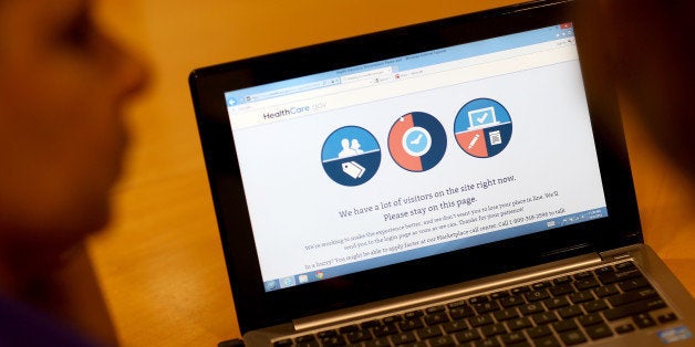 MIAMI, FL - OCTOBER 08: A message is seen on the computer indicating that there are too many visitors on the Affordable Care Act site to continue, as navigator Nini Hadwen helps people shop for health insurance during a navigation session put on by the Epilepsy Foundation Florida to help people sign up for health insurance under the Affordable Care Act on October 8, 2013 in Miami, Florida. The United States government continues to be partially shut down as Republicans hold out hope to cut funding for the Affordable Care Act. (Photo by Joe Raedle/Getty Images)