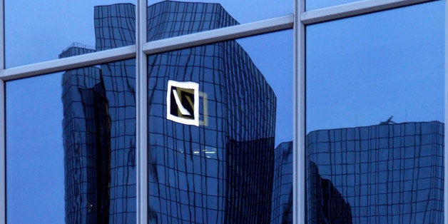 The Deutsche Bank AG headquarters are reflected in the window of a building in Frankfurt, Germany, on Monday, Jan. 30, 2012.