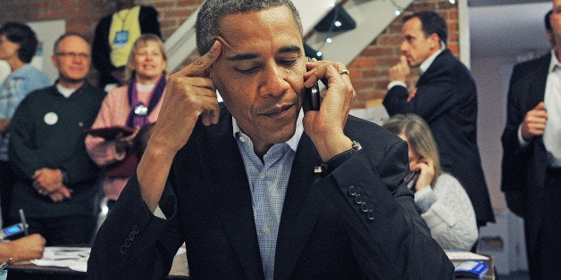 US President Barack Obama calls volunteers as he visits a campaign office in Columbus, Ohio, on November 5, 2012. After a grueling 18-month battle, the final US campaign day arrived Monday for Obama and Republican rival Mitt Romney, two men on a collision course for the world's top job. The candidates have attended hundreds of rallies, fundraisers and town halls, spent literally billions on attack ads, ground games, and get out the vote efforts, and squared off in three intense debates. AFP PHOTO/Jewel Samad (Photo credit should read JEWEL SAMAD/AFP/Getty Images)