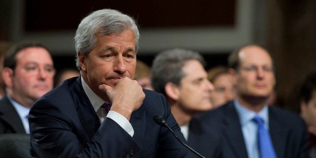 UNITED STATES - JUNE 13: Jamie Dimon, chairman of the board, president and CEO of JPMorgan Chase, prepares to testify at a Senate Banking, Housing and Urban Affairs Committee hearing in Dirksen entitled 'A Breakdown in Risk Management: What Went Wrong at JPMorgan Chase?' The company recently absorbed $2 billion in trading losses. (Photo By Tom Williams/CQ Roll Call)