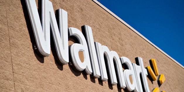 A sign hangs outside a Wal-Mart store in East Peoria, Illinois, U.S., on Wednesday, Feb. 20, 2013. Wal-Mart Stores Inc., the world?s largest retailer, projected first-quarter profit that trailed analysts? estimates as an increase in the payroll tax and delayed refunds curtail spending by its lower-income shoppers. Photographer: Daniel Acker/Bloomberg via Getty Images