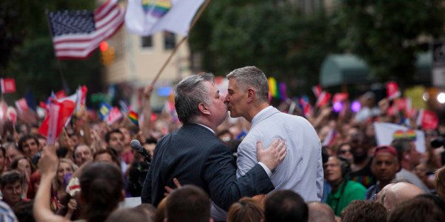 Daniel J. O'Donnell, democratic member of the New York State Assembly, left, kisses his husband John Banta, right, as supporters of same-sex marriage rally on Christopher Street after the U.S. Supreme Court overturned the Defense of Marriage Act (DOMA) and declined to rule on the California law Proposition 8 in New York, U.S., on Wednesday, June 26, 2013. Democratic lawmakers said theyll seek further protections for gay couples after the U.S. Supreme Court struck down part of a federal law denying them benefits, as congressional Republicans signaled that further battles on marriage equality would shift to the states. Photographer: Michael Nagle/Bloomberg via Getty Images 