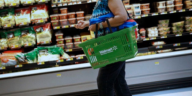 A customer carries a shopping basket during the grand opening of a Wal-Mart Stores Inc. location in the Chinatown neighborhood of Los Angeles, California, U.S., on Thursday, Sept. 19, 2013. Wal-Mart Stores Inc. will phase out 10 chemicals it sells in favor of safer alternatives and disclose the chemicals contained in four product categories, the company announced Sept. 12. Photographer: Patrick T. Fallon/Bloomberg via Getty Images