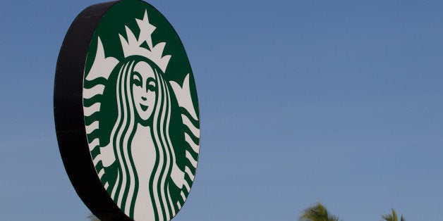 Starbucks Corp. signage stands outside the Discovery Shopping Mall in Kuta, Bali, Indonesia, on Tuesday, Oct. 8, 2013. Bank Indonesia said it will regulate currency hedging by individuals and companies, including state-owned firms, to help stabilize Asias most-volatile currency. Photographer: SeongJoon Cho/Bloomberg via Getty Images