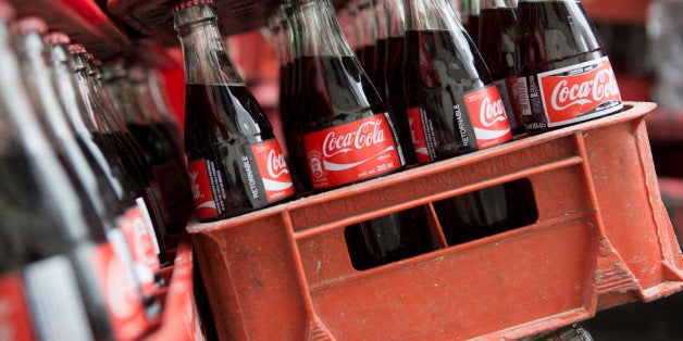 Coca-Cola bottles sit in a delivery truck in Mexico City, Mexico, on Thursday, Sept. 5, 2013. Coca-Cola Femsa SAB, a bottler and distributor of Coca-Cola products in Mexico, agreed to buy Brazils Spaipa SA Industria Brasileira de Bebidas in a cash deal with a total transaction value of $1.86 billion. Photographer: Susana Gonzalez/Bloomberg via Getty Images