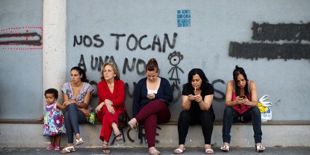 SEVILLE, SPAIN - MAY 30: Women squatting in appartments which is part of a complex occupied by the Corrala Utopia community sit outside chatting on May 30, 2013 in Seville, Spain. In 2010 Spanish banks foreclosed more than 100,000 households which contributed to the already large number of empty houses. With as many as one million properties unsold, victims of Spain's financial crisis, struggling to keep a roof over their head due to high levels of unemployment and severe cuts to social welfare, have turned to squatting in the empty buildings. The Corrala Utopia is a community, on a steadily growing list of communities all over Spain, living in squatted buildings. In this case the building stood empty for three years before the squatters moved in almost a year ago. The community houses a total of 36 families including almost 40 children. The families are cut off from water and electricity and live with an uncertain future and the fear of being evicted soon again. For the first time in history over 6 million Spaniards are jobless in Spain, the euro zone's fourth-biggest economy. (Photo by Jasper Juinen/Getty Images)