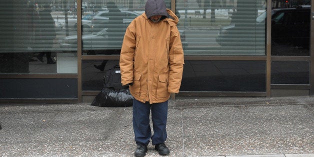 TO GO WITH AFP STORY by Joseph Krauss, US-poverty-homelessA homeless man stands in front of his belongings January 31, 2011 on a street in Washington, DC. Volunteers will begin a head count on January 26 of the homeless in downtown Washington, DC. AFP PHOTO/Mandel NGAN (Photo credit should read MANDEL NGAN/AFP/Getty Images)