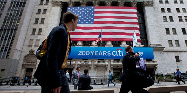 Pedestrians walk past the New York Stock Exchange (NYSE) in New York, U.S., on Monday, June 18, 2012. U.S. stocks swung between gains and losses as a jump in confidence among homebuilders to a five-year high tempered concern about a worsening of Europe?s debt crisis after Spanish bond yields climbed to a euro-era record. Photographer: Jin Lee/Bloomberg via Getty Images
