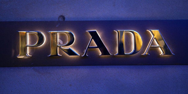 A logo sits outside a Prada SpA luxury clothing store in Frankfurt, Germany, on Monday, Nov. 11, 2013. As the euro area struggles out of the worst recession in its history, attention has turned to whether Germany's trade surplus is hampering economic recovery in countries like Greece and France. Photographer: Krisztian Bocsi/Bloomberg via Getty Images