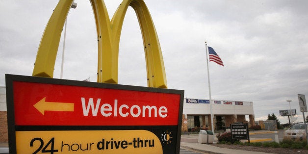 DES PLAINES, IL - OCTOBER 24: A sign directs customers to the drive-thru at a McDonald's restaurant on October 24, 2013 in Des Plaines, Illinois. McDonald's has announced it will make changes to its low-priced Dollar Menu, which includes items like coffee, small fries, hamburgers and apple pies. The new menu, dubbed the Dollar Menu and More, will offer some higher priced options such as the grilled Onion Cheddar Burger and a McChicken sandwich. (Photo by Scott Olson/Getty Images)