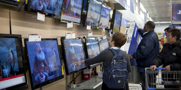 QUINCY, MA - NOVEMBER 23: Shoppers look at televisions at Walmart during the Black Friday sales on November 23, 2012 in Quin