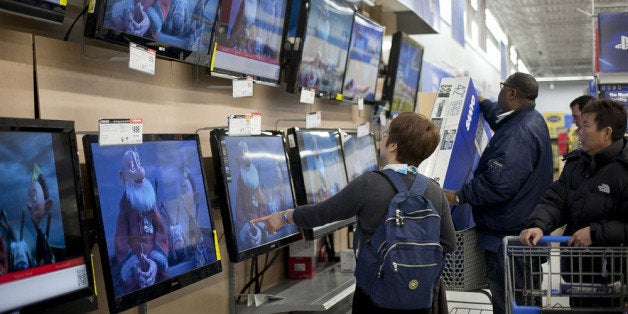 QUINCY, MA - NOVEMBER 23: Shoppers look at televisions at Walmart during the Black Friday sales on November 23, 2012 in Quincy, Massachusetts. Black Friday, the start of the holiday shopping season, has traditionally been the busiest shopping day in the United States. (Photo by Allison Joyce/Getty Images)