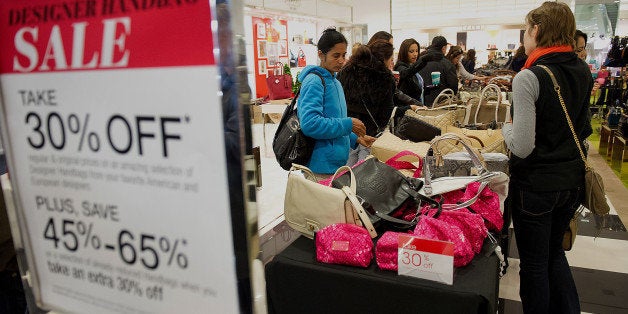 Shoppers browse handbags on sale at a Bloomingdale's store in the Westfield San Francisco Centre in San Francisco, California, U.S., on Friday, Nov. 23, 2012. To get shoppers to spend more than last year, retailers have continued to turn Black Friday, originally a one-day event after Thanksgiving, into a week's worth of deals and discounts. Photographer: David Paul Morris/Bloomberg via Getty Images