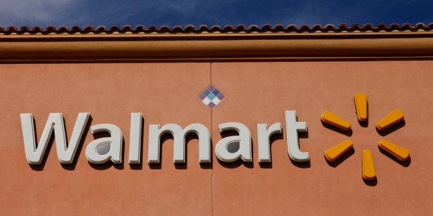 Wal-Mart Stores Inc. signage is displayed outside of a location ahead of Black Friday in Los Angeles, California, U.S., on Tuesday, Nov. 26, 2013. Wal-Mart Stores Inc. said Doug McMillon, head of its international business, will replace Mike Duke as chief executive officer when he retires as the world's largest retailer struggles to ignite growth at home and abroad. Photographer: Patrick T. Fallon/Bloomberg via Getty Images