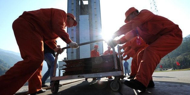 Chinese workers make final preparations to the launch pad at the Xichang Satellite Launch Centre in the southwestern province of Sichuan on December 1, 2013. China made final preparations to launch its first lunar rover mission, the latest step in an ambitious space programme seen as a symbol of its rising global stature, as state media promised blanket coverage of the launch, scheduled for 1:30 am December 2 (1730 GMT Sunday), of the Chang'e-3 rocket carrying the 'Jade Rabbit' rover. CHINA OUT AFP PHOTO (Photo credit should read STR/AFP/Getty Images)