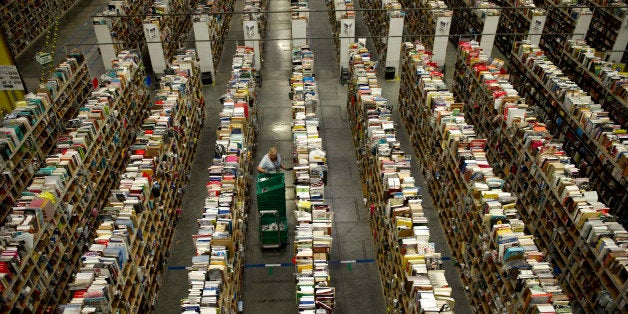 An employee stows items at the Amazon.com Inc. fulfillment center in Phoenix, Arizona, U.S. on, Sunday, Dec. 1, 2013. More than 131 million consumers are expected to shop Cyber Monday events, up from 129 million last year, according to the National Retail Federation. Photographer: David Paul Morris/Bloomberg via Getty Images