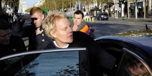 US Mike Jeffries, CEO of US clothing retailer Abercrombie & Fitch leaves the store on the Champs Elysees avenue in Paris on October 27, 2012, as some workers protest against their working conditions. They declared the management did not respect French social rules. AFP PHOTO BERTRAND GUAY (Photo credit should read BERTRAND GUAY/AFP/Getty Images)